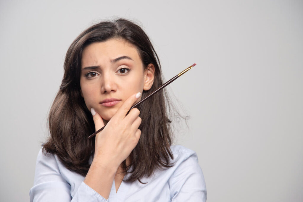 Femme examinant son œil, illustrant les avis négatifs et les effets secondaires possibles du sérum Nanolash.