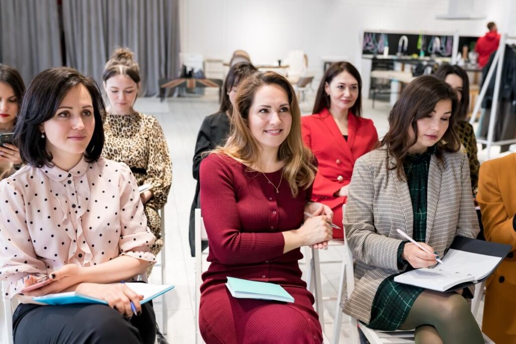 Un groupe d'adultes attentifs participant à un atelier pratique lors d'un stage de perfectionnement en entreprise.