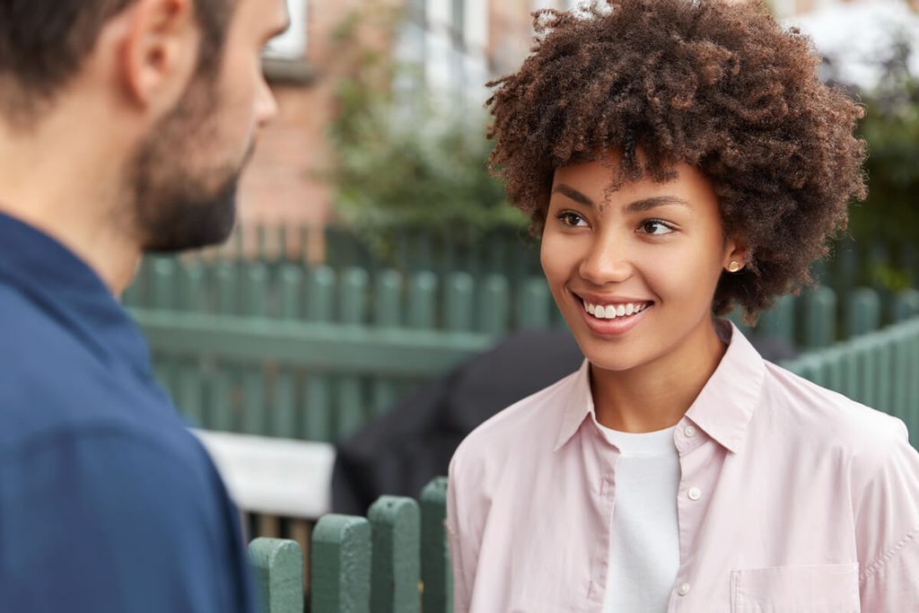 Deux personnes débutant une conversation spontanée après un échange de regards complices.